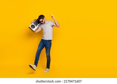 Full Length Body Size View Of Attractive Cool Guy Dancing Listening Hip Hop Isolated Over Vivid Yellow Color Background