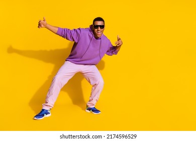 Full length body size view of attractive cheerful guy having fun rest street style isolated over bright yellow color background - Powered by Shutterstock