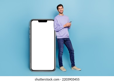 Full length body size view of handsome guy using device gadget big large copy space ad isolated over bright blue color background - Powered by Shutterstock