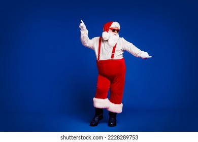 Full length body size view of his he attractive cool funny playful fat white-haired Santa having fun dancing rock day isolated bright vivid shine vibrant red burgundy maroon color background