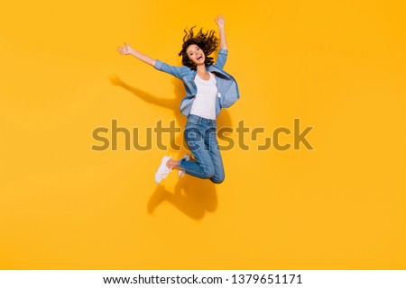 Full length body size view photo playful childish cute lady move holidays glad laughter raise hands travel summer candid freedom active energetic denim suit sneakers legs isolated vibrant background