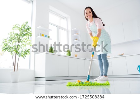 Full length body size view of her she nice attractive cheerful cheery hardworking girl making fast domestic work wiping perfect ceramic floor in modern light white interior kitchen indoors