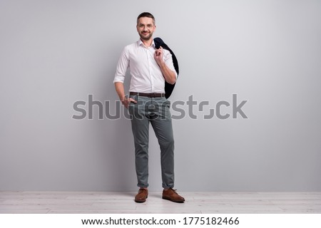Full length body size view of his he nice attractive content cheery mature man wearing classy look posing holding blazer isolated over light gray pastel color background