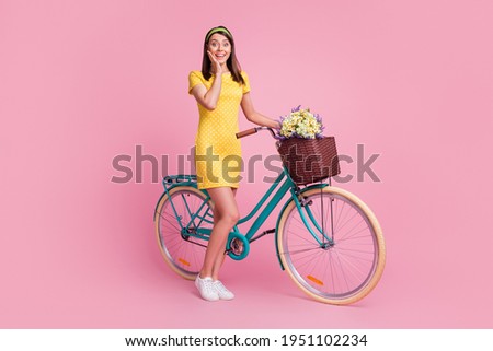 Full length body size view of nice attractive cheerful girl walking riding bicycle enjoying spare time isolated on pink color background