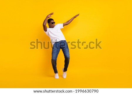 Full length body size view of attractive cheerful guy dancing pout lips having fun isolated over bright yellow color background