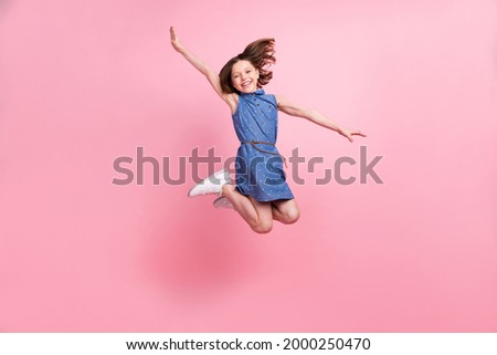 Full length body size view of attractive cheerful girl jumping having fun fooling good mood isolated over pink pastel color background