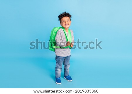 Full length body size view of nice cheerful boy going to first grade isolated over bright blue color background
