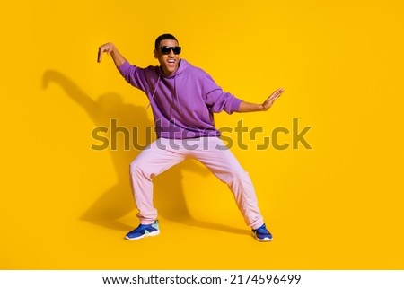 Full length body size view of attractive cheerful guy fooling dancing clubbing isolated over bright yellow color background