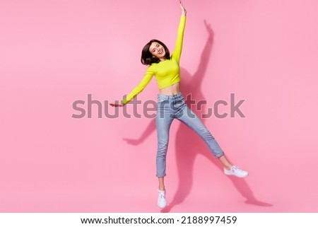 Full length body size view of pretty positive cheery trendy girl jumping isolated on bright pink color background