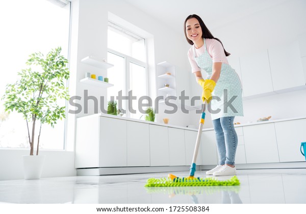 Full\
length body size view of her she nice attractive cheerful cheery\
hardworking girl making fast domestic work wiping perfect ceramic\
floor in modern light white interior kitchen\
indoors