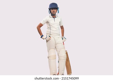 full length of a boy in cricket uniform standing with bat