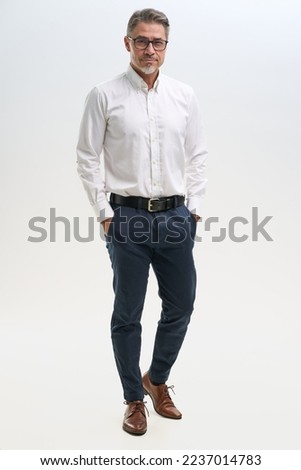 Full length business portrait of confident businessman. Entrepreneur in white shirt, Serious mid adult, mature age man standing, isolated on white background.