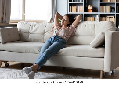 Full Length Calm Woman With Closed Eyes Resting On Cozy Couch, Leaning Back, Enjoying Lazy Leisure Time, Attractive Peaceful Young Female Relaxing, Daydreaming, Taking Nap On Sofa At Home