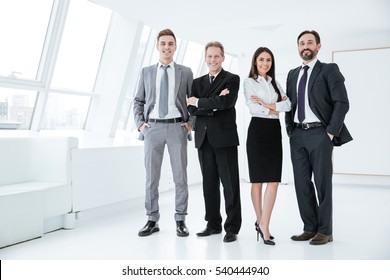 Full Length Confident Business Team Stands In Office