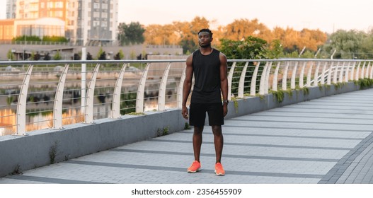 Full length of confident young African man in sportswear preparing to morning jog outdoors - Powered by Shutterstock