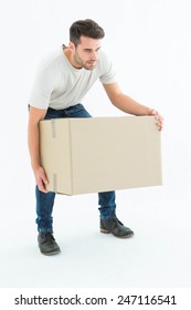 Full Length Of Courier Man Picking Up Cardboard Box On White Background