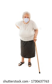 Full Length Of An Elderly Woman With A Cane Wearing A Protective Face Mask Isolated On White Background