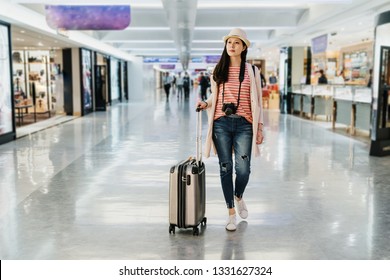 Full Length Of Elegant Confident Travel Young Girl Shopping Tax Free Area. Beautiful Lady With Luggage Suitcase Walk In Duty Free Store Shop While Waiting For Plane Departure In Lobby Gate Terminal