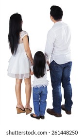 Full Length Of Family Standing In The Studio While Looking Back, Isolated Over White Background