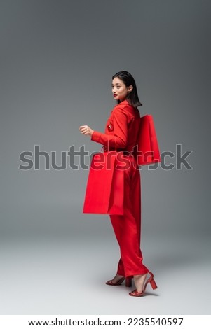 Similar – Image, Stock Photo Woman with a red coat behind a white column, heavily overexposed.