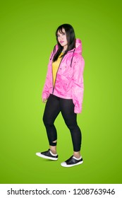 Full Length Of Female Hip Hop Dancer Looks Confident While Standing In The Studio With Green Screen