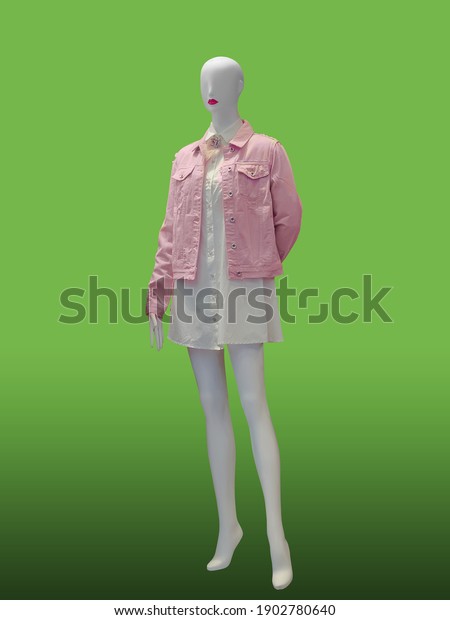 Full length female mannequin dressed in\
fashionable clothes, isolated on green background. No brand names\
or copyright objects.