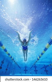 Full Length Of Female Swimmer In United States Swimsuit Swimming In Pool