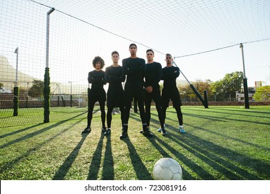 Full length of five a side football team on field during training. Soccer players standing together on football pitch. - Powered by Shutterstock