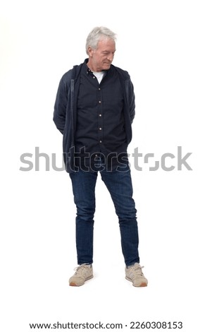 full length front view portrait of a man looking down at the ground on white background