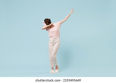 Full Length Fun Young Woman In Pajamas Jam Sleep Eye Mask Rest Relax At Home Do Dab Hip Hop Dance Hands Move Gesture Youth Sign Cover Face Isolated On Pastel Blue Background Good Mood Bedtime Concept.