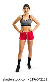 Full Length Of A Gorgeous Mexican Woman Looking Happy And Excited Before Exercising In Front Of A White Background