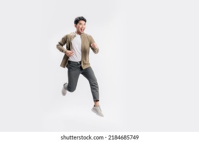 Full length handsome Asian man excited smile he is run in air on isolated white background. Cool man joyful running in copy space. Studio short. - Shutterstock ID 2184685749