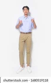 Full Length Handsome Casual Man Wearing Fashion Striped Shirt With Khakis Pants And Doing Positive Gesture With Hand, Thumbs Up Standing  On White Background,

