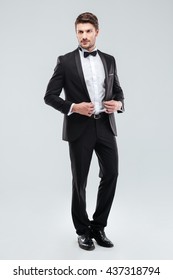 Full Length Of Handsome Young Man In Tuxedo With Bowtie Standing