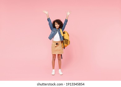 Full Length Happy Little African American Kid School Girl 12-13 Year Old In Casual Denim Clothes Backpack Stand With Raised Up Hands Show Palms Isolated On Pink Background Childhood Education Concept.