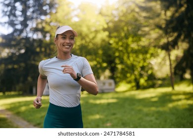 Full length of happy woman jogging in the park. Copy space. - Powered by Shutterstock