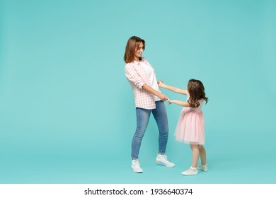 Full Length Happy Woman In Pink Clothes Have Fun With Cute Child Baby Girl 5-6 Years Old. Mommy Little Kid Daughter Dancing Isolated On Pastel Blue Background Studio. Mother's Day Love Family Concept