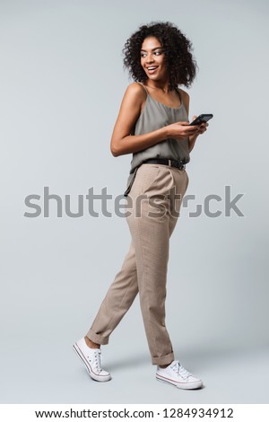 Similar – Image, Stock Photo Black woman in trendy attire wearing scarf isolated on yellow background