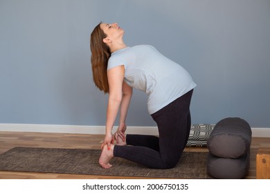 Full length healthy pregnant woman doing yoga exercising stretching at home - Powered by Shutterstock