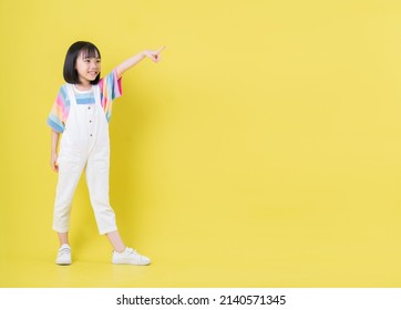 Full Length Image Of Asian Child Posing On Yellow Background