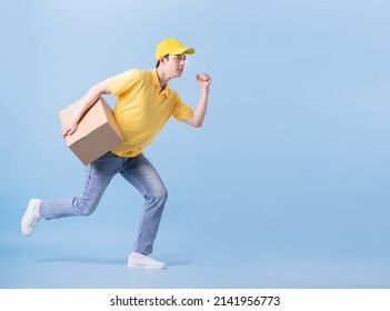 Full Length Image Of Asian Delivery Man On Blue Background