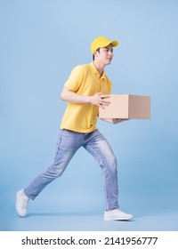 Full Length Image Of Asian Delivery Man On Blue Background