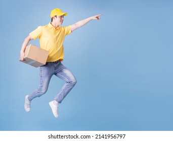 Full Length Image Of Asian Delivery Man On Blue Background