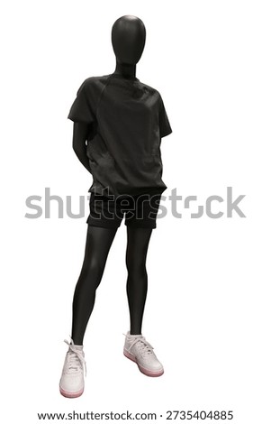 Full length image of a child display mannequin wearing black t-shirt and shorts isolated on white background
