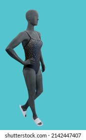 Full length image of a female display mannequin wearing fashionable bathing suit isolated on a blue background