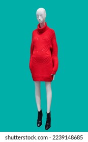Full length image of a female display mannequin wearing fashionable red wool knitted dress isolated on green background - Shutterstock ID 2239148685