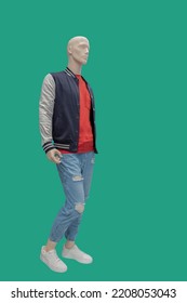 Full Length Image Of A Male Display Mannequin Wearing Sports Jacket And Blue Ripped Jeans Isolated On Green Background