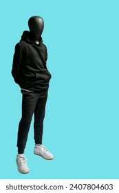 Full length image of a male display mannequin wearing black sports suit isolated on blue background