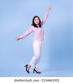 Full Length Image Of Middle Aged Asian Woman On Blue Background