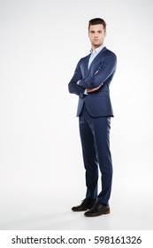 Full Length Image Of Serious Business Man Which Posing In Studio With Crossed Arms And Looking At Camera. Isolated White Background